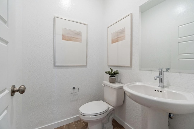 4433 N Phoenix, Fresno, CA 93723 - bathroom featuring wood finished floors, toilet, baseboards, and a sink