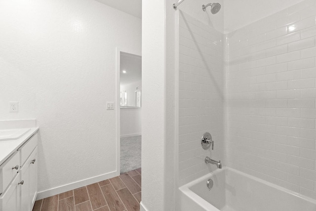 4433 N Phoenix, Fresno, CA 93723 - bathroom featuring tub / shower combination, wood tiled floors, vanity, and baseboards