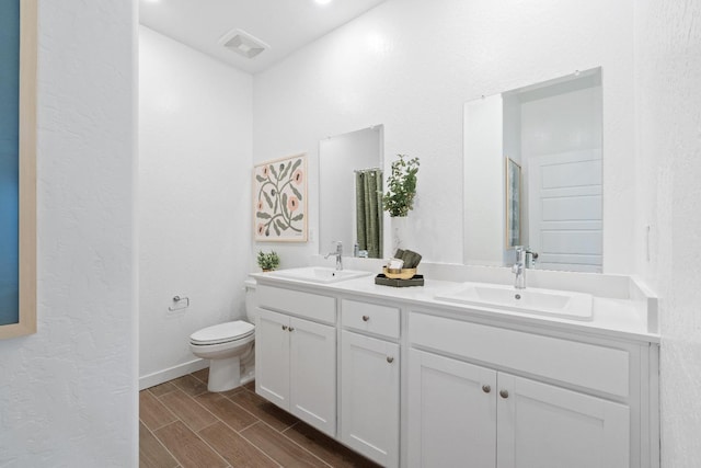 4433 N Phoenix, Fresno, CA 93723 - full bathroom featuring double vanity, toilet, and wood finish floors