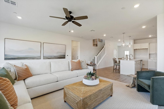 4433 N Phoenix, Fresno, CA 93723 - living area featuring stairs, light wood-style flooring, recessed lighting, ceiling fan, and baseboards