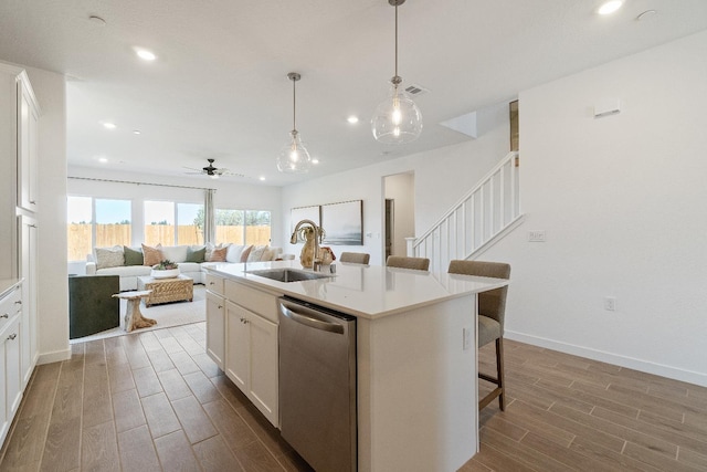4433 N Phoenix, Fresno, CA 93723 - kitchen with stainless steel dishwasher, a sink, recessed lighting, dark wood finished floors, and white cabinetry