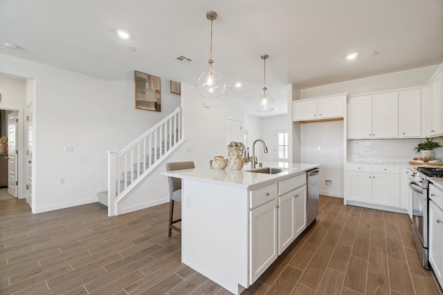 4433 N Phoenix, Fresno, CA 93723 - kitchen featuring a sink, stainless steel appliances, dark wood-type flooring, white cabinetry, and recessed lighting