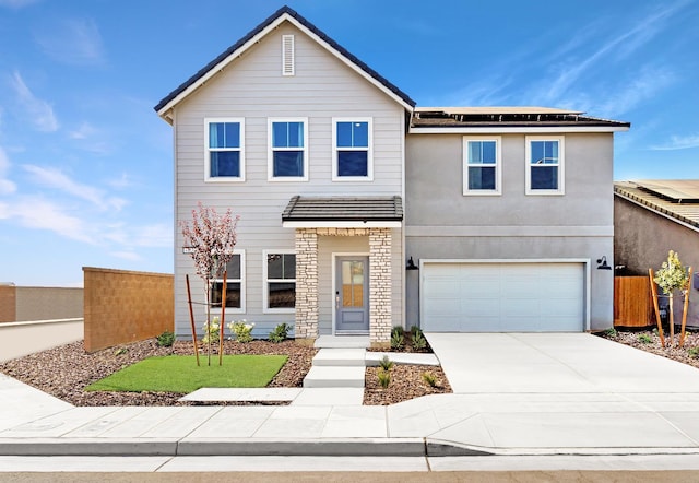 4433 N Phoenix, Fresno, CA 93723 - traditional-style home with solar panels, concrete driveway, an attached garage, and stone siding