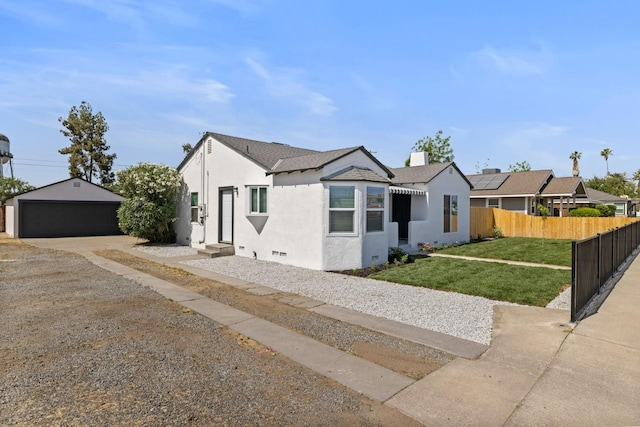 view of front of property with stucco siding, a detached garage, an outdoor structure, entry steps, and roof with shingles