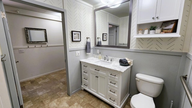 55062 Oak Crest Ct, Wishon, CA 93669 - bathroom with vanity, toilet, stone finish floors, and baseboards