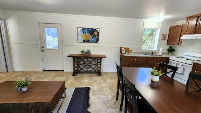 55062 Oak Crest Ct, Wishon, CA 93669 - kitchen featuring white stove, a sink, under cabinet range hood, light countertops, and baseboards