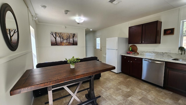 55062 Oak Crest Ct, Wishon, CA 93669 - kitchen featuring stainless steel dishwasher, freestanding refrigerator, dark brown cabinets, light stone counters, and a sink