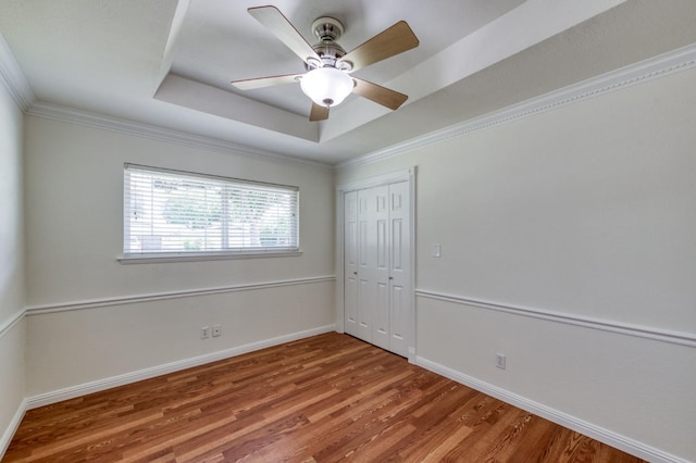 5753 N 7th St, Fresno, CA 93710 - unfurnished bedroom featuring a raised ceiling, wood finished floors, a closet, baseboards, and ceiling fan