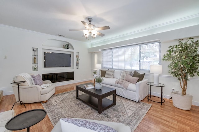 5753 N 7th St, Fresno, CA 93710 - living room with ceiling fan, crown molding, wood finished floors, and baseboards