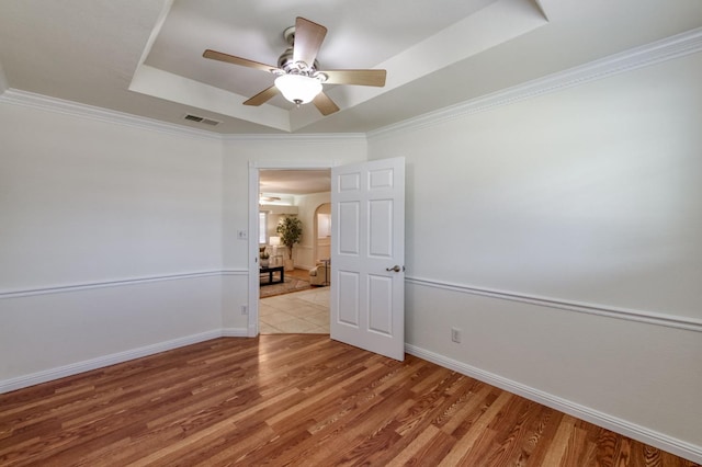 5753 N 7th St, Fresno, CA 93710 - unfurnished room featuring a tray ceiling, ceiling fan, wood finished floors, baseboards, and crown molding