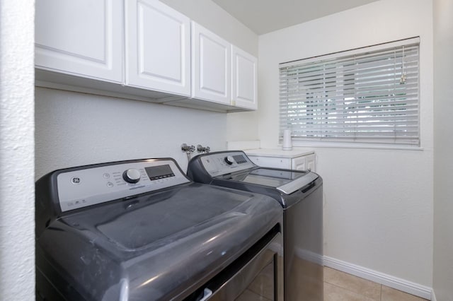 5753 N 7th St, Fresno, CA 93710 - laundry area with washing machine and dryer, cabinet space, baseboards, and light tile patterned floors