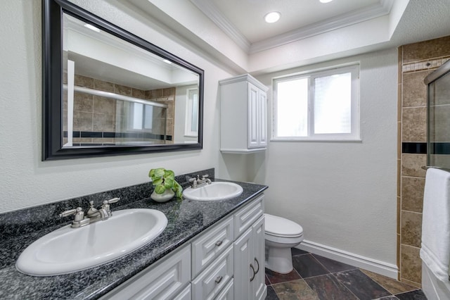 5753 N 7th St, Fresno, CA 93710 - full bathroom featuring crown molding, a tile shower, double vanity, toilet, and baseboards
