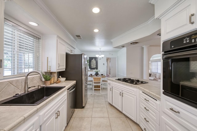 5753 N 7th St, Fresno, CA 93710 - kitchen with a sink, black appliances, a chandelier, white cabinets, and tile counters