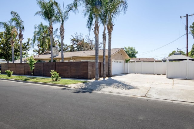 5753 N 7th St, Fresno, CA 93710 - view of front of home featuring concrete driveway, stucco siding, and an attached garage