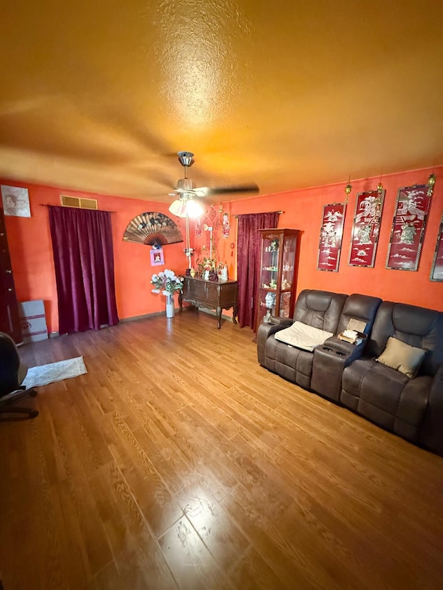 1584 N Carruth Ave, Fresno, CA 93728 - living area with wood finished floors, ceiling fan, and a textured ceiling