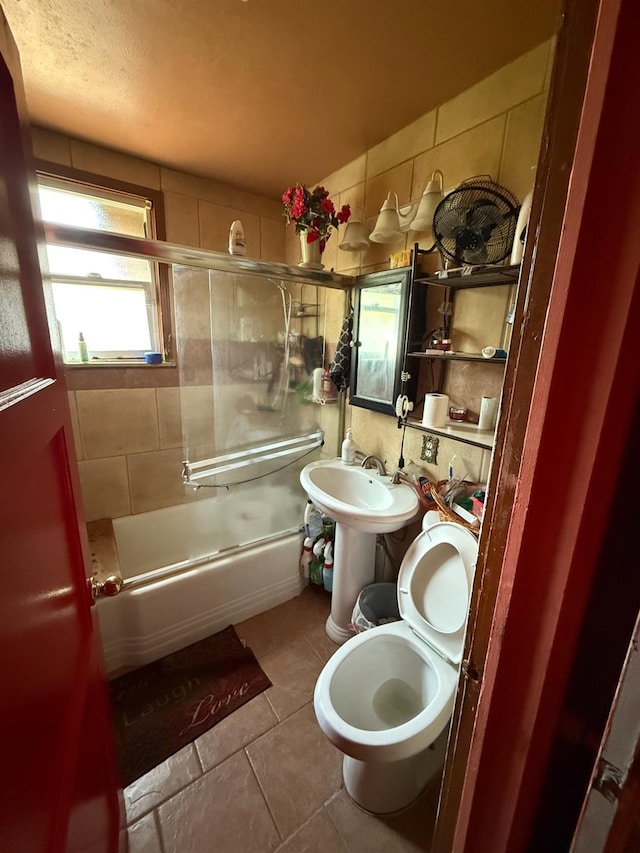 1584 N Carruth Ave, Fresno, CA 93728 - bathroom with combined bath / shower with glass door, tile patterned floors, and toilet
