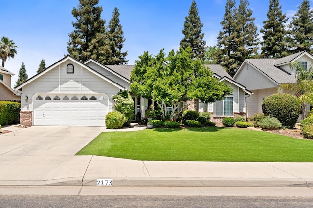 2173 Spruce, Clovis, CA 93611 - view of front of home with brick siding, a front yard, driveway, and an attached garage