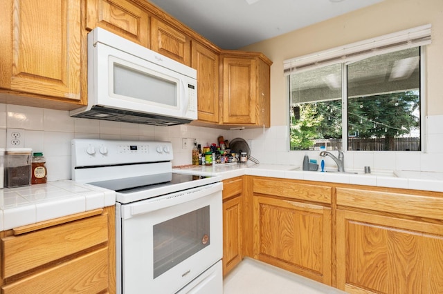 2173 Spruce, Clovis, CA 93611 - kitchen featuring white appliances, tasteful backsplash, a sink, and tile counters