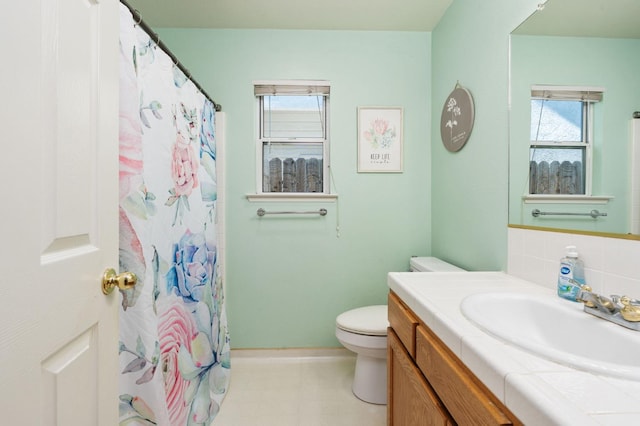 2173 Spruce, Clovis, CA 93611 - full bathroom with vanity, toilet, baseboards, and healthy amount of natural light