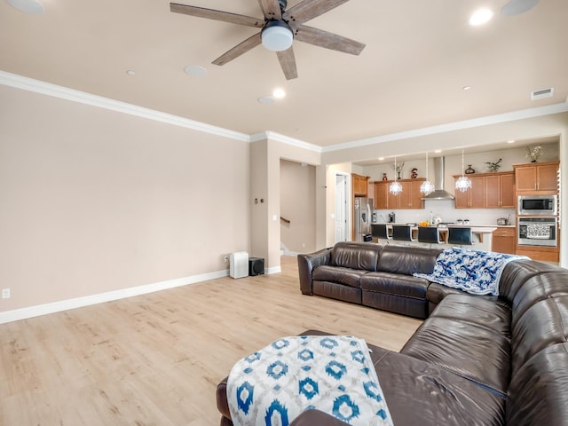 2127 Chennault Ave, Clovis, CA 93611 - living room featuring a ceiling fan, ornamental molding, light wood finished floors, baseboards, and recessed lighting