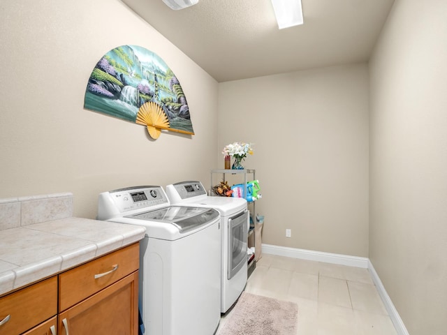 2127 Chennault Ave, Clovis, CA 93611 - washroom with independent washer and dryer, cabinet space, baseboards, and light tile patterned floors