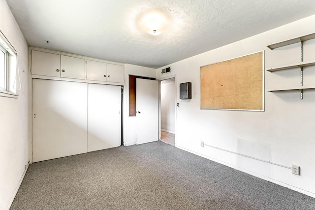 5495 E Atchison St, Fresno, CA 93727 - unfurnished bedroom with baseboards, a closet, electric panel, and a textured ceiling