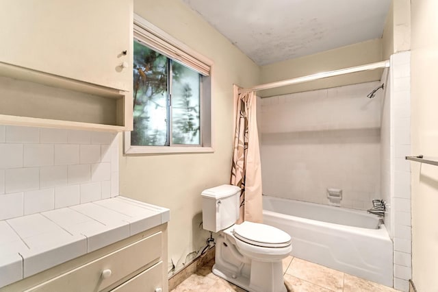 5495 E Atchison St, Fresno, CA 93727 - bathroom with shower / bath combination with curtain, toilet, decorative backsplash, tile patterned flooring, and vanity