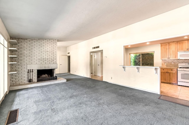 5495 E Atchison St, Fresno, CA 93727 - unfurnished living room featuring light colored carpet and a brick fireplace
