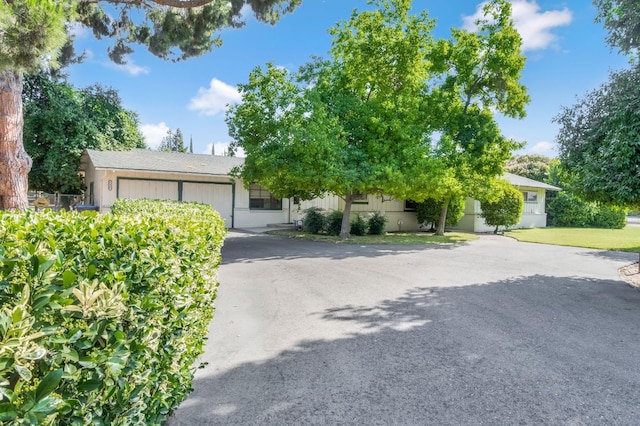 5495 E Atchison St, Fresno, CA 93727 - obstructed view of property with a garage and driveway