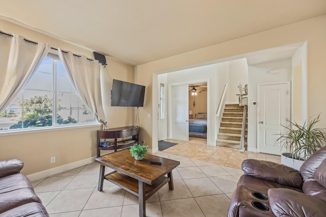 3615 W Sunnyview Ave NW, Visalia, CA 93291 - living area featuring light tile patterned floors, baseboards, stairway, and ceiling fan