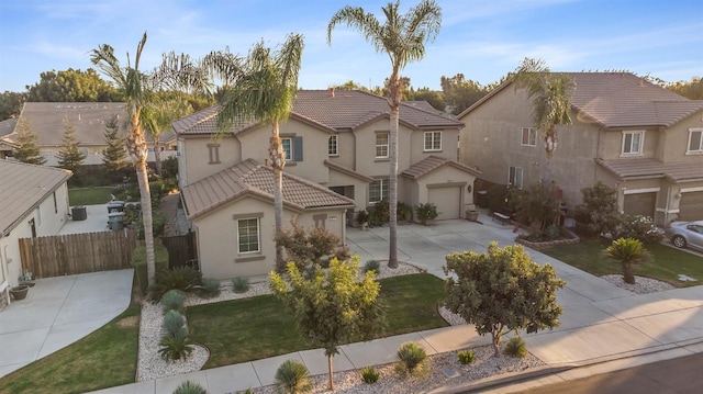 3615 W Sunnyview Ave NW, Visalia, CA 93291 - view of front of property featuring driveway, stucco siding, a tiled roof, a garage, and a residential view