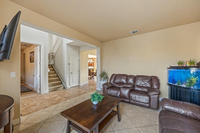 3615 W Sunnyview Ave NW, Visalia, CA 93291 - living room with stairs, light tile patterned floors, a chandelier, and baseboards
