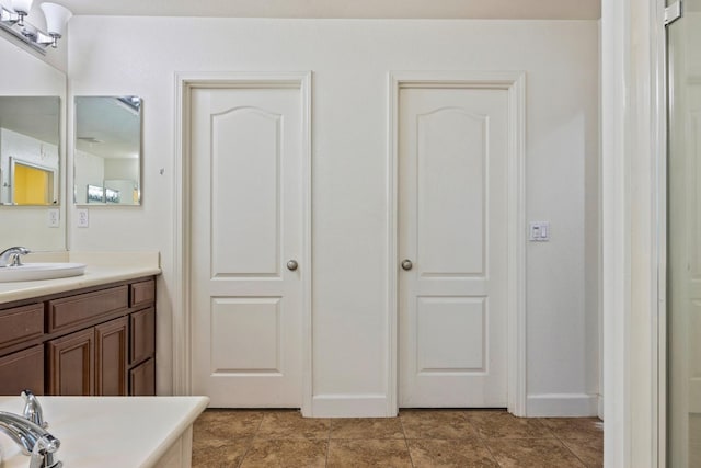 3615 W Sunnyview Ave NW, Visalia, CA 93291 - bathroom with vanity, baseboards, and tile patterned floors