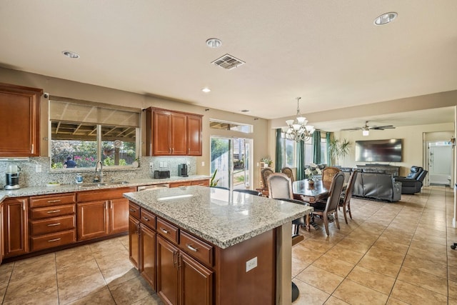 3615 W Sunnyview Ave NW, Visalia, CA 93291 - kitchen featuring a sink, open floor plan, decorative backsplash, a chandelier, and recessed lighting