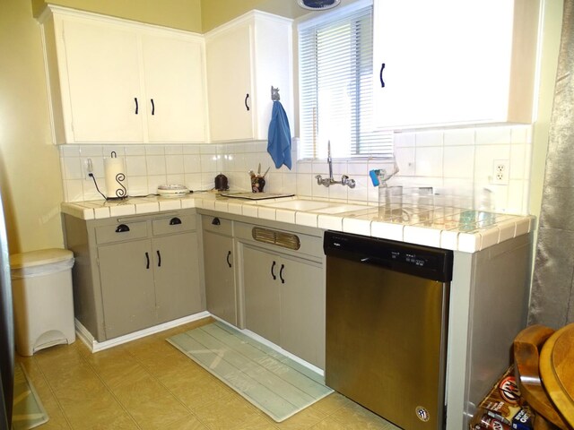 4457 E Brown Ave, Fresno, CA 93703 - kitchen with dishwasher, a sink, backsplash, and tile countertops
