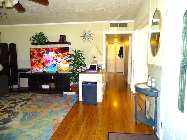 4457 E Brown Ave, Fresno, CA 93703 - living room featuring a textured ceiling, wood finished floors, and a ceiling fan