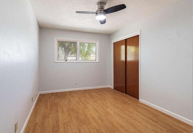 6224 N 3rd St, Fresno, CA 93710 - unfurnished bedroom featuring a textured ceiling, light wood-style floors, a closet, and a ceiling fan