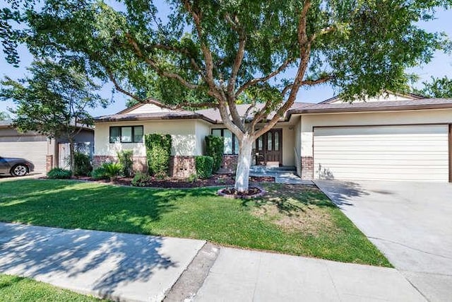 6224 N 3rd St, Fresno, CA 93710 - ranch-style house with brick siding, a garage, driveway, a front yard, and stucco siding