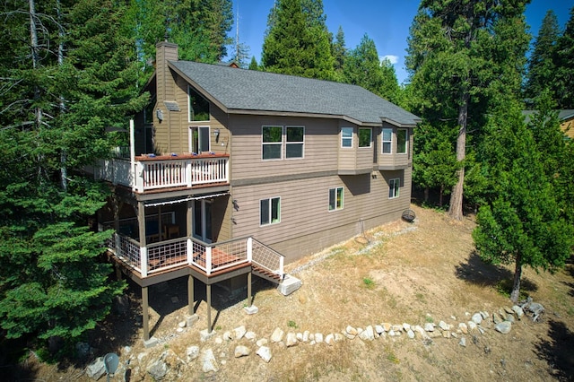40753 Wild Iris Ln, Shaver Lake, CA 93664 - rear view of house with a chimney, a wooden deck, and roof with shingles