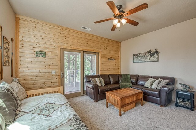 40753 Wild Iris Ln, Shaver Lake, CA 93664 - living room with wooden walls, ceiling fan, and carpet