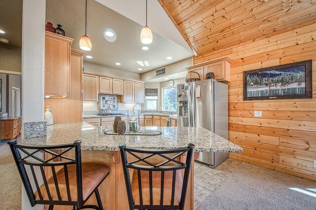 40753 Wild Iris Ln, Shaver Lake, CA 93664 - kitchen with stainless steel refrigerator with ice dispenser, lofted ceiling, wooden walls, a peninsula, and light brown cabinetry