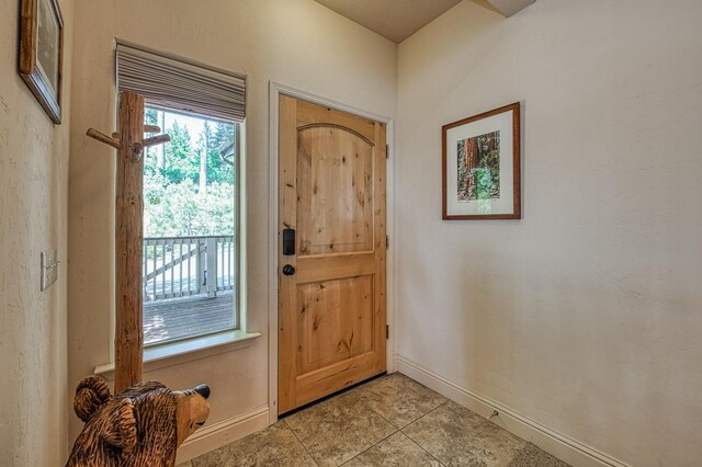 40753 Wild Iris Ln, Shaver Lake, CA 93664 - entryway featuring baseboards and light tile patterned floors