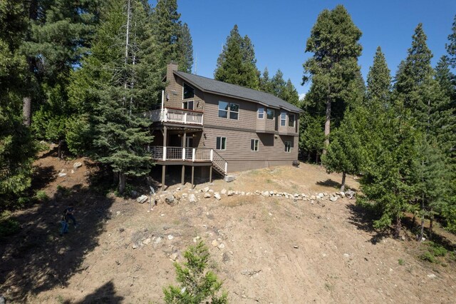 40753 Wild Iris Ln, Shaver Lake, CA 93664 - rear view of house with a deck, a chimney, and stairs