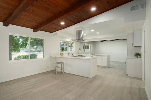 5610 N Arthur Ave, Fresno, CA 93711 - kitchen featuring island range hood, a peninsula, wooden ceiling, light wood finished floors, and light countertops