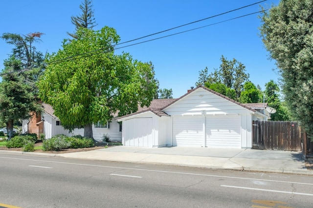 5610 N Arthur Ave, Fresno, CA 93711 - ranch-style home featuring driveway, an outbuilding, a tile roof, and a garage