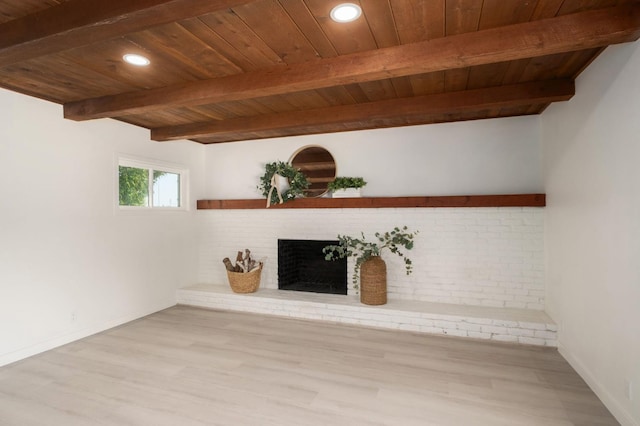 5610 N Arthur Ave, Fresno, CA 93711 - unfurnished living room with a wooden ceiling with exposed beams, light wood-style flooring, a brick fireplace, and recessed lighting