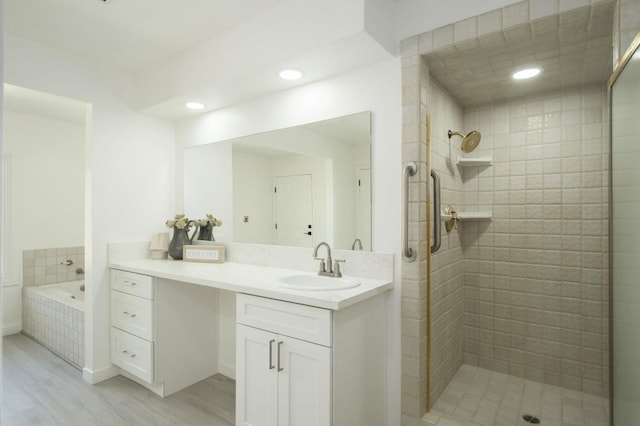 5610 N Arthur Ave, Fresno, CA 93711 - full bath featuring wood finished floors, vanity, a tile shower, a bath, and recessed lighting