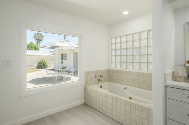5610 N Arthur Ave, Fresno, CA 93711 - full bathroom featuring a whirlpool tub, vanity, and wood finished floors