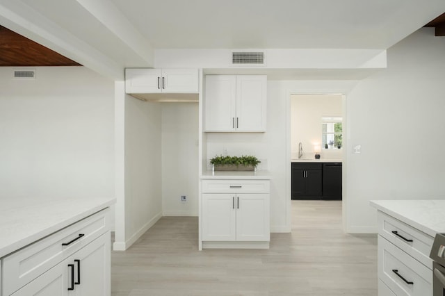 5610 N Arthur Ave, Fresno, CA 93711 - kitchen with light wood-style floors and white cabinetry