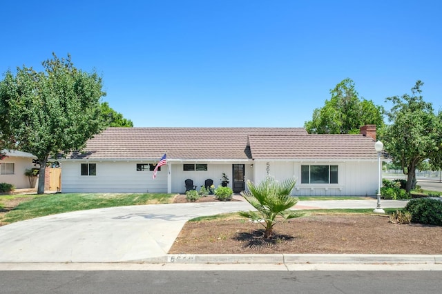 5610 N Arthur Ave, Fresno, CA 93711 - single story home featuring a tiled roof, a chimney, and concrete driveway